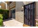 Close-up of front door of home with security gate and well maintained landscaping at 4630 N 68Th St # 264, Scottsdale, AZ 85251