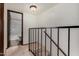 Upstairs hallway with a black iron railing; bathroom is seen through doorway at 4630 N 68Th St # 264, Scottsdale, AZ 85251