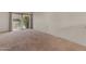 Spacious living room featuring large sliding glass doors and neutral carpeting at 4630 N 68Th St # 264, Scottsdale, AZ 85251