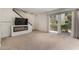 Spacious living room featuring a modern fireplace, sliding glass door and plush carpeting at 4630 N 68Th St # 264, Scottsdale, AZ 85251