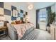 Cozy bedroom with a daybed, decorative pillows, and a modern cloud light fixture at 4792 E Shasta Dr, San Tan Valley, AZ 85143