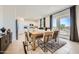 Elegant dining area with a wooden table, stylish chairs, and a view into the kitchen at 4792 E Shasta Dr, San Tan Valley, AZ 85143