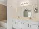 Bright bathroom features a double sink vanity with white cabinets and large mirror at 4845 W Evans Dr, Glendale, AZ 85306