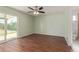 Spacious bedroom featuring wood floors, a ceiling fan, and sliding glass door access to the yard at 4845 W Evans Dr, Glendale, AZ 85306