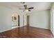 Main bedroom features wood floors, ceiling fan, and an en-suite bathroom with arched doorway at 4845 W Evans Dr, Glendale, AZ 85306