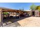 Functional backyard area with covered sheds, providing ample storage and workspace at 49478 W Val Vista Rd, Maricopa, AZ 85139