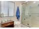 This bathroom features tile walls, a window with blinds, and a shower with a sliding glass door at 49478 W Val Vista Rd, Maricopa, AZ 85139