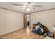 A bedroom with laminate flooring, a ceiling fan, and clutter on the floor at 49478 W Val Vista Rd, Maricopa, AZ 85139