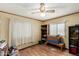 Bedroom showcasing wood-look floors, a window with blinds, and ceiling fan at 49478 W Val Vista Rd, Maricopa, AZ 85139