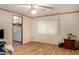 The bedroom features wood-look floors, a closet, a window with blinds, and a ceiling fan at 49478 W Val Vista Rd, Maricopa, AZ 85139