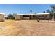 Modest single story home with a large dirt front yard and a chain link fence in a rural environment at 49478 W Val Vista Rd, Maricopa, AZ 85139
