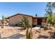 Side view of home with accessible ramp and desert landscaping featuring cacti at 49478 W Val Vista Rd, Maricopa, AZ 85139