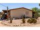 Side view of home exterior with desert landscaping featuring various cacti at 49478 W Val Vista Rd, Maricopa, AZ 85139