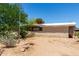 Desert home featuring gravel landscaping, a small covered porch, and neutral siding at 49478 W Val Vista Rd, Maricopa, AZ 85139
