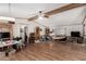 Spacious living room with wood laminate flooring and exposed beams at 49478 W Val Vista Rd, Maricopa, AZ 85139