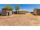Exterior shot of several outbuildings and sheds in a gravel backyard setting at 49478 W Val Vista Rd, Maricopa, AZ 85139