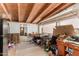 A sunroom with a wood ceiling, linoleum floor, a refrigerator, and cluttered surfaces at 49478 W Val Vista Rd, Maricopa, AZ 85139