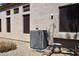 Outside shot of the AC unit on the side of the house next to several windows at 6966 E Bramble Berry Ln, Scottsdale, AZ 85266