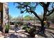 Relaxing back patio featuring desert landscaping, dining table, and scenic views at 6966 E Bramble Berry Ln, Scottsdale, AZ 85266
