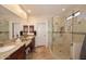Bright bathroom featuring granite countertops, double sinks, and a glass-enclosed shower at 6966 E Bramble Berry Ln, Scottsdale, AZ 85266