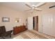 Bedroom featuring neutral decor, a ceiling fan, closet and dresser with a picture on the wall at 6966 E Bramble Berry Ln, Scottsdale, AZ 85266