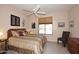 Bedroom with neutral tones, a ceiling fan, and a comfortable bed with decorative pillows at 6966 E Bramble Berry Ln, Scottsdale, AZ 85266