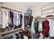 Walk-in closet with ample storage space and a variety of clothing neatly organized at 6966 E Bramble Berry Ln, Scottsdale, AZ 85266