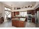 Open kitchen with granite counters, large island, and breakfast nook with large windows at 6966 E Bramble Berry Ln, Scottsdale, AZ 85266