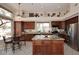 Open kitchen with granite counters, large island, and breakfast nook with views at 6966 E Bramble Berry Ln, Scottsdale, AZ 85266