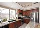 Bright kitchen features granite counters, stainless appliances, and a large window overlooking the yard at 6966 E Bramble Berry Ln, Scottsdale, AZ 85266