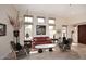 Bright living room with tile floors, neutral walls, tall windows, and comfortable seating at 6966 E Bramble Berry Ln, Scottsdale, AZ 85266