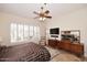 Comfortable main bedroom with plantation shutters, ceiling fan, and dresser at 6966 E Bramble Berry Ln, Scottsdale, AZ 85266