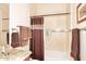 Bathroom shower with a neutral shower curtain, bathtub, and a granite countertop sink at 6966 E Bramble Berry Ln, Scottsdale, AZ 85266