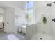 Bright bathroom featuring a modern soaking tub, glass shower, and contemporary fixtures at 7144 E Lakeview Ave, Mesa, AZ 85209