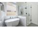 Bright bathroom featuring a modern soaking tub, glass shower, and contemporary fixtures at 7144 E Lakeview Ave, Mesa, AZ 85209
