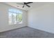 Bright bedroom featuring a large arched window with cactus curb appeal and a neutral color palette at 7144 E Lakeview Ave, Mesa, AZ 85209