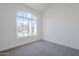 Bright bedroom featuring a large window with curb appeal and a neutral color palette at 7144 E Lakeview Ave, Mesa, AZ 85209