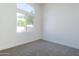 Bright bedroom with high window and neutral decor overlooking backyard at 7144 E Lakeview Ave, Mesa, AZ 85209