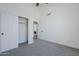 Bright bedroom featuring a closet, ceiling fan, ensuite access, and neutral color palette at 7144 E Lakeview Ave, Mesa, AZ 85209