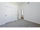 Bedroom featuring neutral carpet, closet and entry door and modern style at 7144 E Lakeview Ave, Mesa, AZ 85209