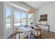 Inviting dining area with views of the pool through expansive windows, perfect for relaxed meals and entertaining at 7144 E Lakeview Ave, Mesa, AZ 85209