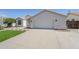 Home's front exterior featuring a two-car garage and desert landscaping at 7144 E Lakeview Ave, Mesa, AZ 85209
