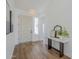Welcoming foyer with wood-look floors, white walls, and stylish decor that sets a bright and airy tone at 7144 E Lakeview Ave, Mesa, AZ 85209