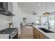 Bright, open kitchen with white countertops, wood cabinets, and stainless steel appliances overlooking the spacious living area at 7144 E Lakeview Ave, Mesa, AZ 85209