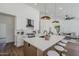 Modern kitchen features a large island with seating, pendant lighting, and stainless steel appliances for a sleek design at 7144 E Lakeview Ave, Mesa, AZ 85209