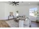 Spacious living room with vaulted ceiling, wood floors, and neutral decor at 7144 E Lakeview Ave, Mesa, AZ 85209