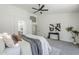Bright main bedroom featuring soft carpet, ceiling fan, ensuite access, and contemporary accents at 7144 E Lakeview Ave, Mesa, AZ 85209