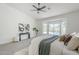 Bright main bedroom featuring soft carpet, ceiling fan, pool views, and contemporary accents at 7144 E Lakeview Ave, Mesa, AZ 85209