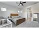 Bright bedroom featuring a wooden bed frame, crib, and ample natural light at 7694 W Desert Spoon Dr, Peoria, AZ 85383