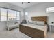 Cozy bedroom with a wooden bed frame, white crib, and natural light at 7694 W Desert Spoon Dr, Peoria, AZ 85383